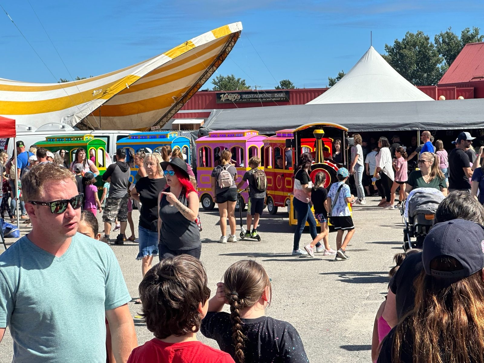 A Maze N Fun portable train operating at a festival