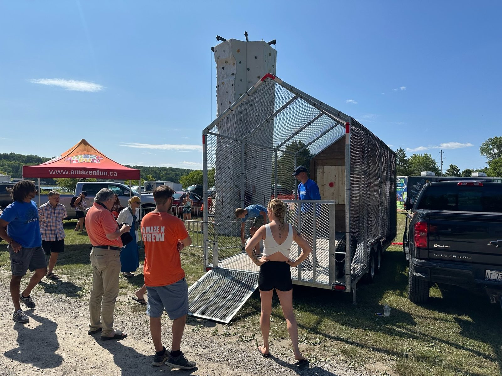 A Maze N Fun rock wall at a busy outdoor event